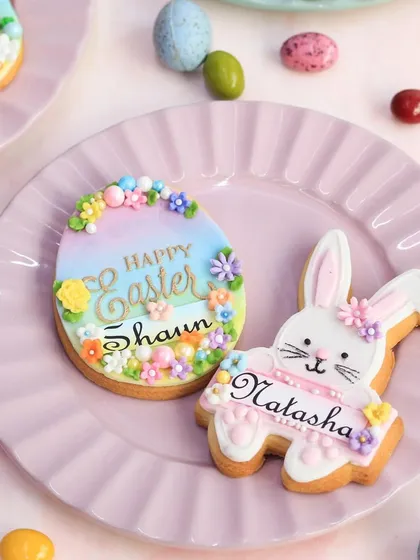 A close-up of the personalized Easter cookies, showing the intricate icing work and cheerful designs.