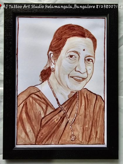 A beautifully detailed blood portrait of an elderly woman, likely a mother or grandmother. The artwork captures her warm smile and is set in a simple, elegant black frame.