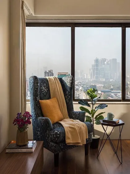 We all need a quiet corner. This reading nook, with its comfortable wingback chair and stunning city view, was designed as a personal escape within the home.