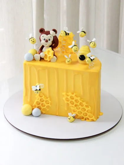 Another view of the sweet honeybee-themed half birthday cake.