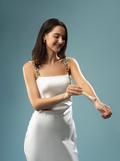 A lifestyle shot demonstrating the use of a razor on the arm. This shows the product in action in a relatable way.