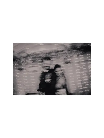 A creative black and white photo using slow shutter speed. This artistic shot captures the movement and emotion of the couple during their reception celebration.