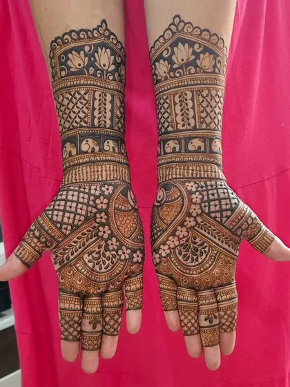 A gorgeous design for a bride or siders, featuring peacocks on the palms and bands of elephants and lotuses on the wrists.