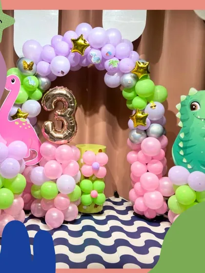 A dino-mite dinosaur-themed birthday! This party features cute dinosaur cutouts and a colorful balloon arch, ready for a prehistoric adventure.