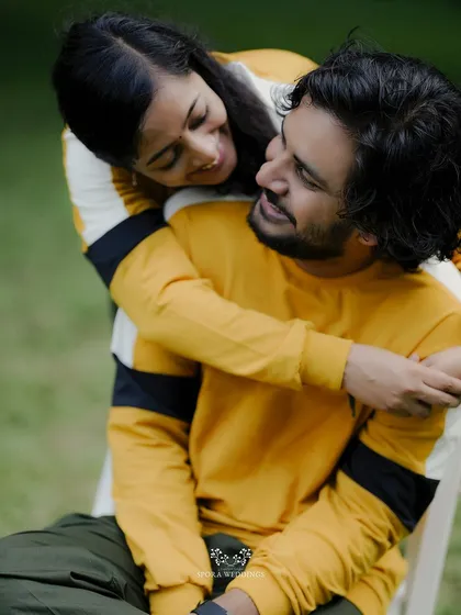 An intimate close-up of the couple, her arms wrapped around him, sharing a look of pure affection.