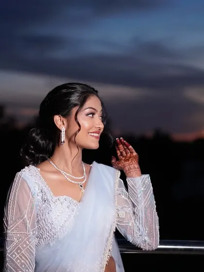 Another beautiful shot against the sunset. The warm light catches the highlight on her cheekbones, showcasing the dewy finish of her makeup.
