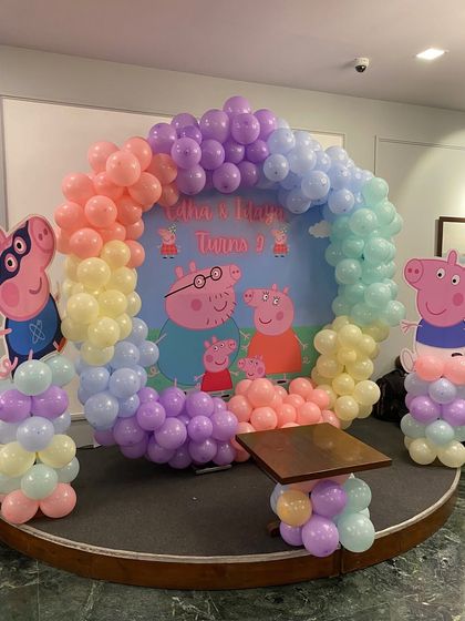 A full view of the Peppa Pig stage setup with a custom backdrop and character cutouts.