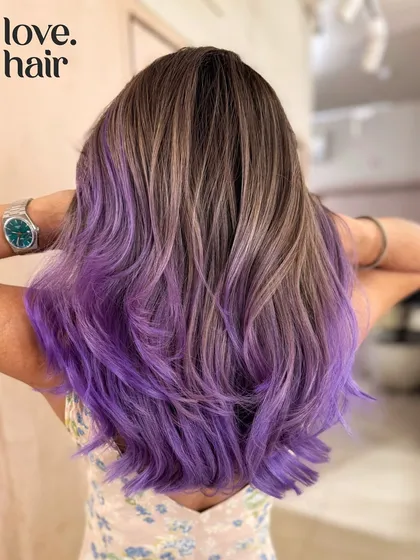 When you can't decide, mix them both. We blended a cool ash brown balayage with a vibrant purple for a look that's the best of both worlds: natural and edgy.