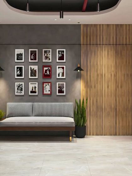A lounge area in an office featuring a mix of modern and industrial elements, with a comfortable daybed and a gallery wall.