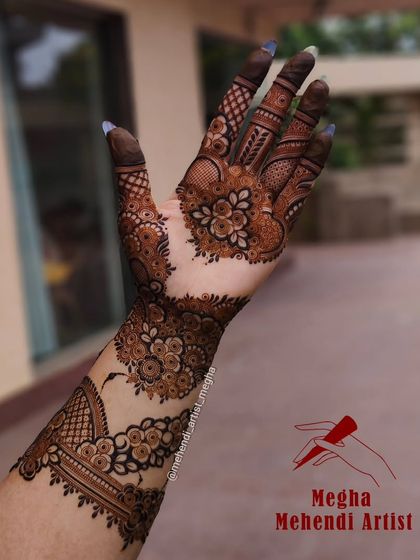 A stylish floral vine design that wraps around the arm and hand, creating a beautiful flow of art from the wrist to the fingertips.