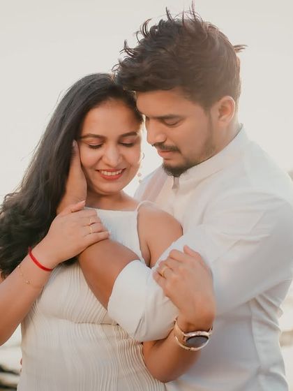 A tender embrace against the bright, sunlit backdrop of the beach. This photo perfectly captures the warmth and affection between the couple.
