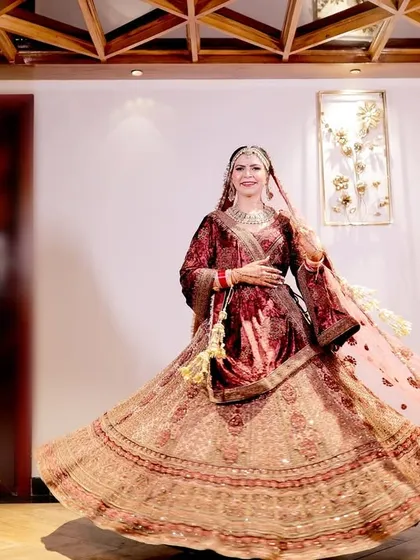 A beautiful twirling shot of the bride in her wedding lehenga, showing the full flare of the skirt.