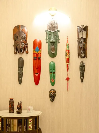 We often use art to reflect a client's personality and travels. This collection of decorative masks from various cultures creates a rich and personal focal point on this wall.