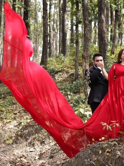 A playful moment captured in the woods. The movement of the red trail adds energy and life to the photo, showing the fun side of your love story.