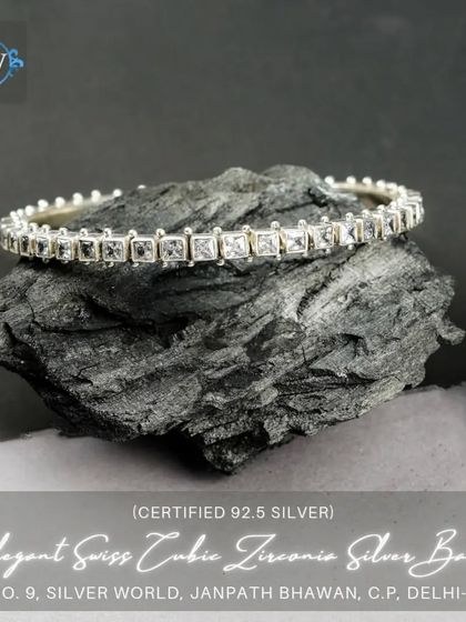 An elegant bangle set with a single row of square-cut cubic zirconia. This piece offers a clean, modern sparkle.