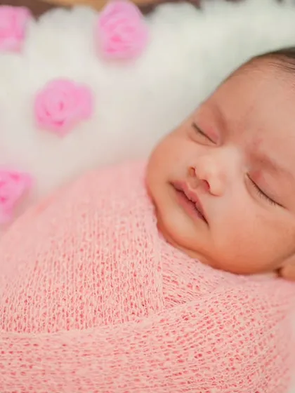 Another angle of the newborn in the heart basket, showing the delicate details of the baby's features. These posed shots are a specialty of my newborn photography service in Bangalore.