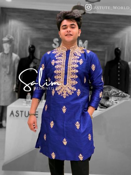 A client in a royal blue silk kurta with gold embroidery around the neckline. The rich color and classic design make it a standout piece.