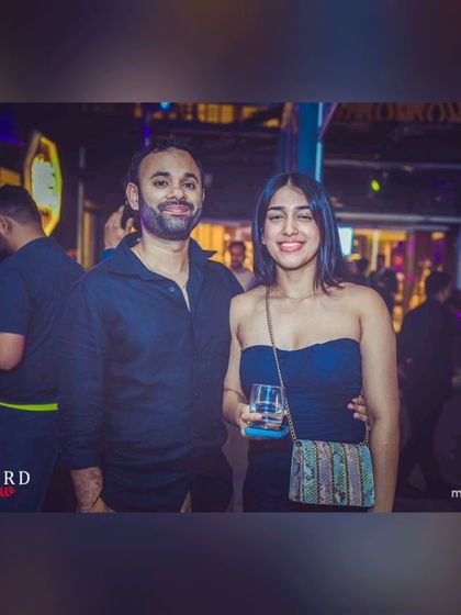 A couple enjoying the relaxed yet vibrant atmosphere at the Seven Rivers poolside. It's a perfect spot for a date night.