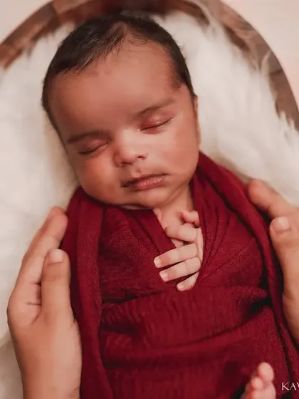 A peaceful newborn nestled in a heart-shaped bowl. I use soft wraps and textures to keep the baby comfortable and secure during these solo portraits.
