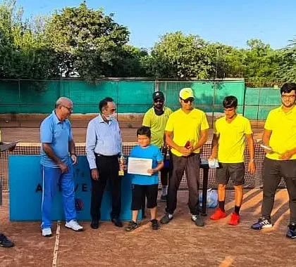 A young player from the Under-8 group receiving his certificate of participation from our esteemed guests at an academy event.