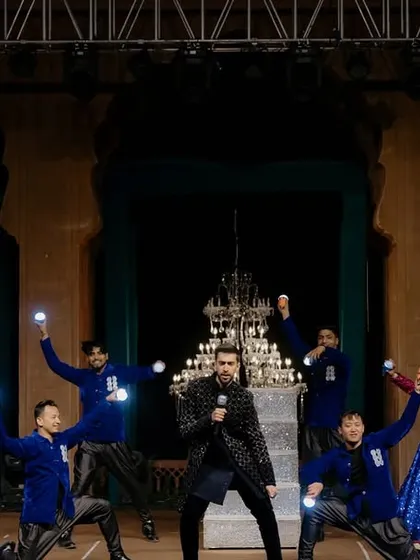 A powerful moment from the groom's performance. We used illuminated ball props to create a dynamic visual effect that complemented the high-energy choreography and royal stage setting.