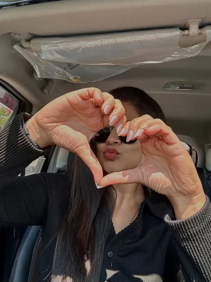 The heart hands pose says it all. This client is loving her clean and classic manicure, a simple yet beautiful statement.