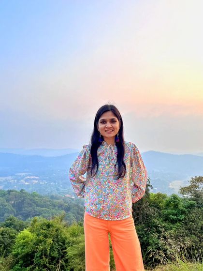 A happy portrait against the stunning backdrop of the Coorg hills at sunset. Travel and art bring me so much joy.