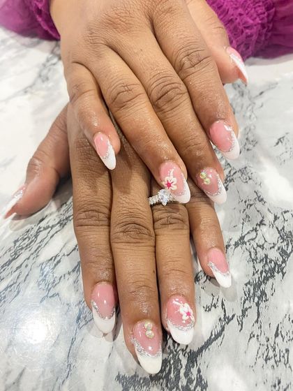 A perfect example of a classic French manicure with a creative twist. The student added delicate lace-like details and 3D floral elements, making it an ideal design for a bride.