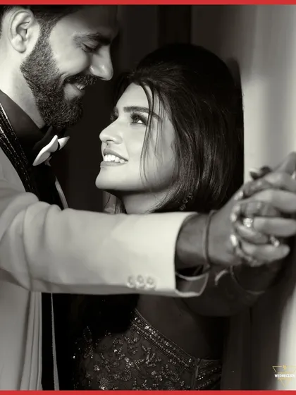 A close-up black and white shot of the couple, their joyful expressions and intertwined hands creating a powerful image of love.