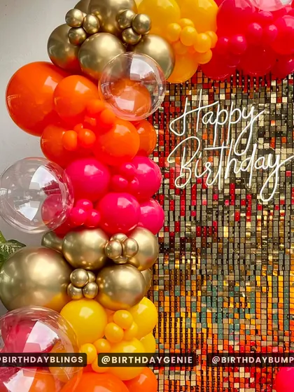 A close-up of the neon sign and the warm, glittering effect of the shimmer wall.