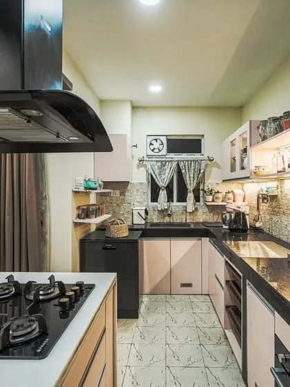 A kitchen with soft pink and black cabinets, demonstrating a unique and modern color combination.