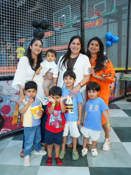 A group of moms and their kids gather for a photo. Our play zone is a popular spot for playdates and group outings.