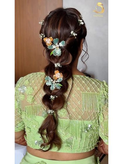 A detailed back view of the soft, messy braid adorned with beautiful floral clips.