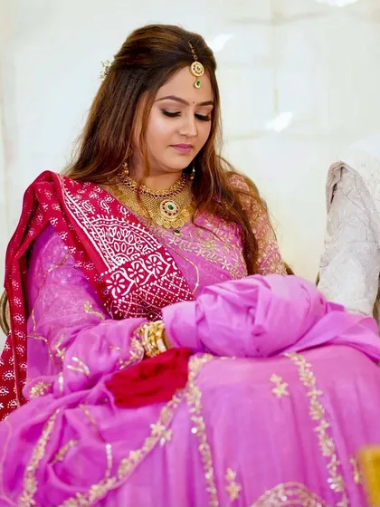 A pretty pink bridal look perfect for a day wedding. The makeup is soft and radiant, with gentle waves in the hair, allowing the bride's happy glow to be the centerpiece.