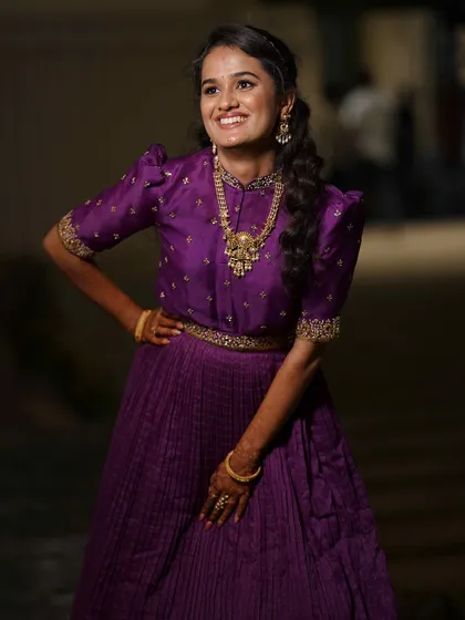 A joyful and confident pose from our client in her custom purple gown.