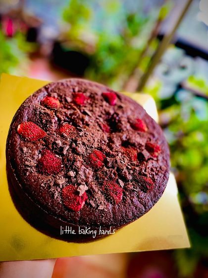 A top-down view of the whole wheat chocolate strawberry cake. The combination of rich chocolate and fresh berries is a classic for a reason.