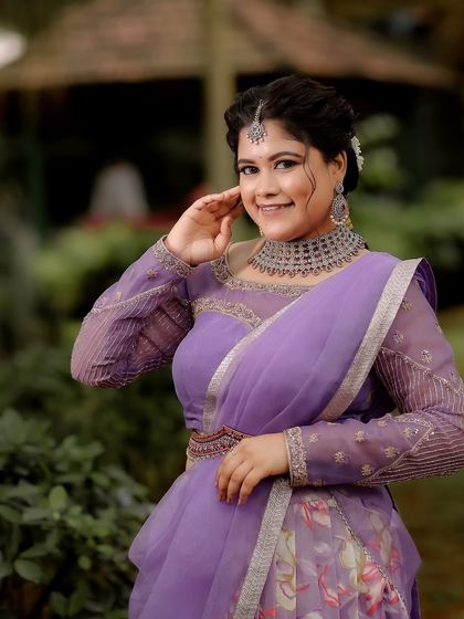 A full view of the model, showing how the modern choker and maang tikka complement a contemporary half-saree look.