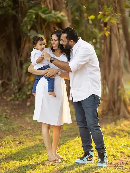 A quiet, loving moment between a family of three, surrounded by the beauty of nature.