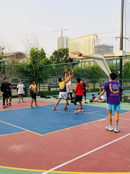 Two players jump for the rebound, showing the competitive spirit of our training sessions.