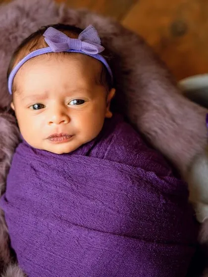 Even when awake, a snug wrap helps babies feel secure. This little one is looking right at the camera, allowing us to capture their beautiful eyes.