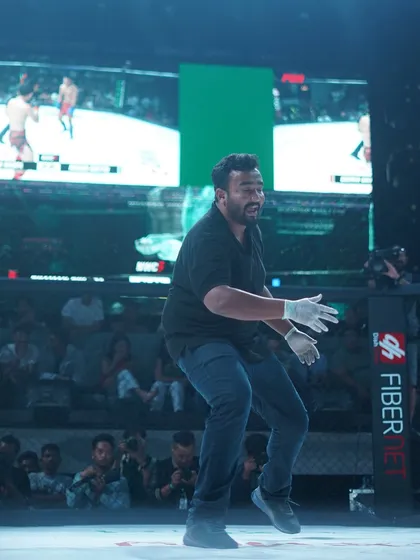 Moving around the cage to get the best angle. Refereeing requires just as much focus and movement as fighting.
