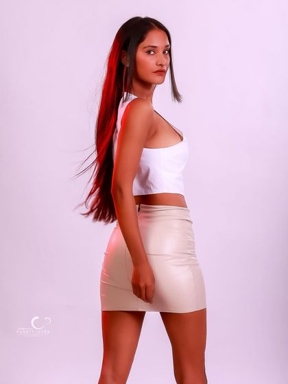 A confident and stylish pose that highlights the modern outfit. The red rim light adds a pop of color and dimension.