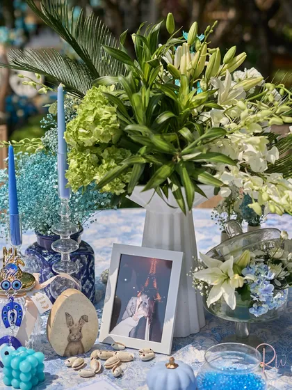 A full view of a tablescape, showing how all the different elements, from flowers to photos to trinkets, come together to create a cohesive story.