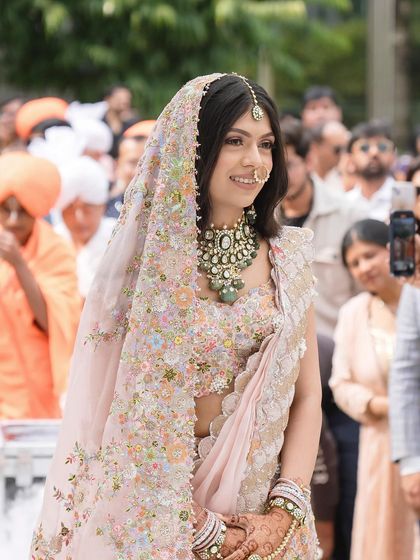 A close up of Tanisha walking down the aisle, her soft makeup looking flawless and radiant.