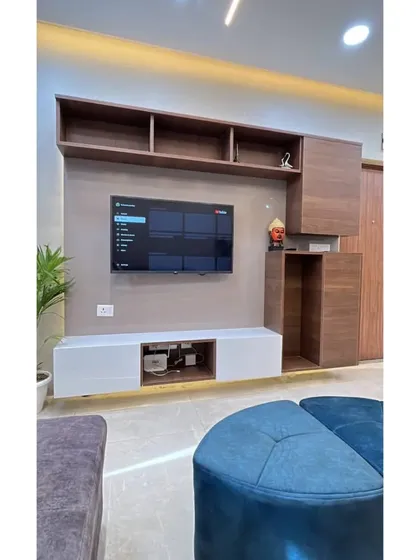 This view highlights the floating design of the TV console, which is enhanced by warm LED strip lighting underneath.