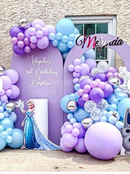 An elaborate outdoor "Frozen" theme for a 3rd birthday. I used custom-shaped backdrops and extensive balloon work in purple and blue, with cutouts of both Elsa and Olaf.