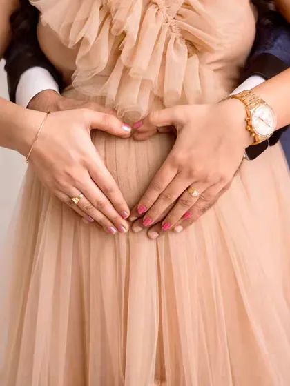 Sometimes the simplest shots are the most powerful. This classic heart-hands pose is a beautiful and intimate way to celebrate your baby bump and the love that surrounds it.