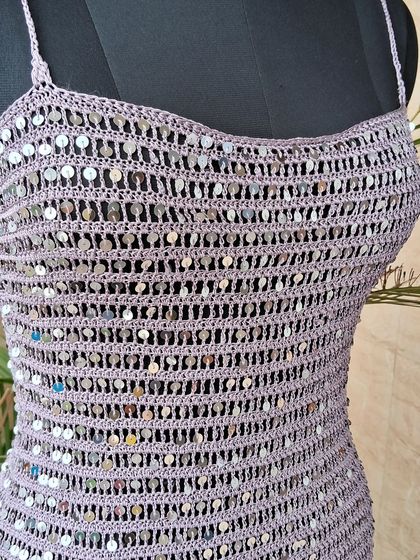 A close-up of the bodice of our sequin dress, showing how each sequin is meticulously woven into the crochet fabric to create a shimmering, textured effect.
