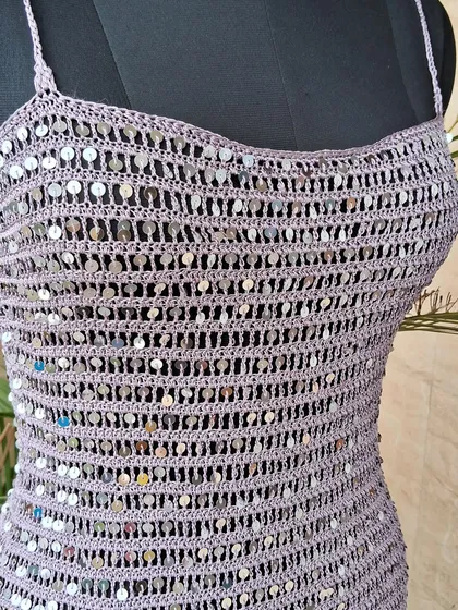 A close-up of the bodice of our sequin dress, showing how each sequin is meticulously woven into the crochet fabric to create a shimmering, textured effect.