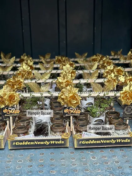 A huge batch of our Golden Jubilee hampers, ready to be shipped. Each hamper was decorated with golden flowers and filled with seven different kinds of treats and a jade plant.